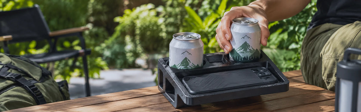 Filazoo ASA-CF camping tray holding drink cans and a phone outdoors